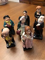 Group view of six Royal Doulton Dickens figurines on table