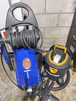 Simoniz pressure washer and Shop-Vac vacuum side by side