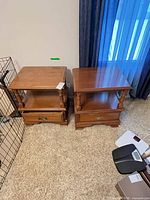 Two matching wooden nightstands showing tops, shelves, drawers
