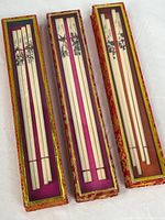 Three presentation boxes with glass tops displaying chopsticks