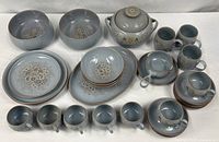Entire Denby Reflections stoneware set laid out on table