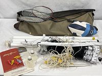 Full lot laid out showing bag, net, poles, rackets, shuttlecocks, ball, pump, rule book, clips