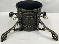 Full view of cast iron tree stand with legs attached