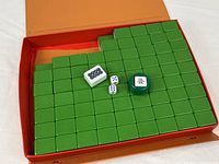 Open vinyl case showing green-backed tiles and accessories