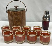 Full lot showing eight glasses, ice bucket, and shaker