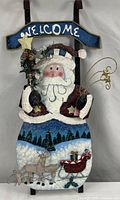 Full view of painted metal Santa Claus welcome sign