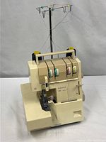 Front angled view showing full serger and spool stand