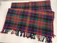 Folded Scottish wool blanket showing full tartan pattern and fringes