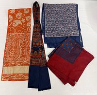 Group shot of all four scarves folded and stacked