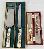 Four serving pieces in their respective presentation boxes