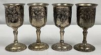 front view of all four embossed silver-plate goblets