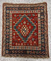 Full view of the hand-knotted prayer rug showing overall pattern and size