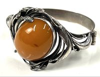 Front view showing oval amber and floral silver surround
