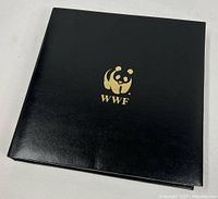 Closed black WWF binder with gold panda logo