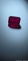 Front view of emerald-cut ruby showing color and shape