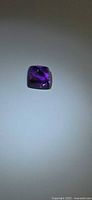 Front view of sugarloaf cut amethyst gemstone