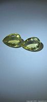 Pair of pear-cut yellow gemstones side by side