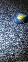 Pear cabochon Ethiopian black opal showing multicolour flashes
