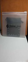 CRWN GEMS branded clear zip pouch with drawstring pouch inside
