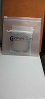 Bracelet inside branded CRWN GEMS drawstring pouch
