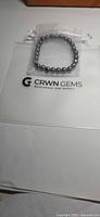Bracelet in pouch on CRWN Gems card
