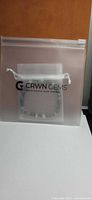 Bracelet in CRWN GEMS pouch inside clear sleeve
