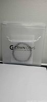 Bracelet in translucent pouch branded CRWN Gems