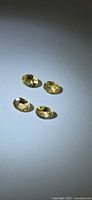 Four oval champagne yellow gemstones on neutral background