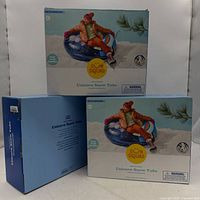 Front view of two boxed Sun Squad unicorn snow tubes stacked, third box side visible