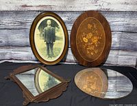 All four items: framed photo, marquetry plaque, rectangular mirror, round mirror