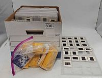overview of file box with slides in sleeves, separate sleeve sheet and bag of Kodak boxes visible