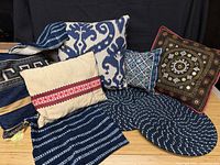 Group shot showing all pillows, pillow cases and both round seat cushions