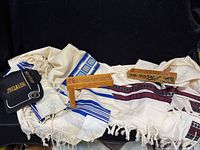 Lot overview showing two tallit, two graggers, Jerusalem cap