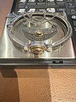 Bangle bracelet and necklace on scale