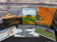 All six landscape paintings displayed together for overview of lot contents