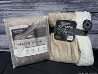 Front view of both Berkshire throws showing packaging and labels
