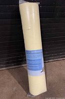 Rolled mattress topper in clear plastic packaging