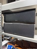 Front view of both Onkyo speakers showing grilles and logos