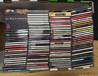 Open box with large stack of CD jewel cases