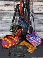 Group shot of all eight bags hanging and seated