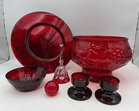 Group shot: large embossed bowl, platter, small bowl, bell, two candlesticks, glass sphere