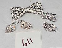 Group shot showing bow brooch, both earring pairs