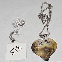 Both sterling silver necklaces: crystal crown pendant with chain, shell heart pendant with chain
