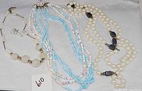 Group shot of all three necklaces and earrings