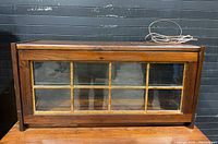 Front view of wooden barrister display case with glass panel door