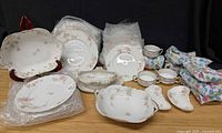 Overall lot view with plates, serving bowls, teacups, bone dishes