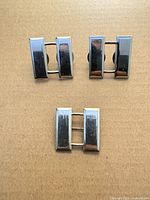 Front view of three sterling silver captain bars