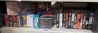 Shelf view showing entire lot with CDs on left and VHS tapes on right