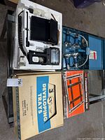 Overall lot showing flash kit, clamp lights, trays and easel