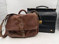 Front view of brown L.L.Bean satchel and black Buffard briefcase